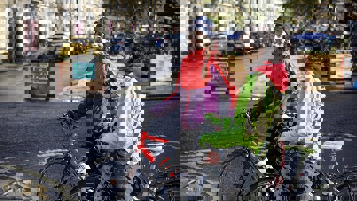 two women sitting on their bikes having a conversation in the street in a Low Traffic Neighbourhood in London