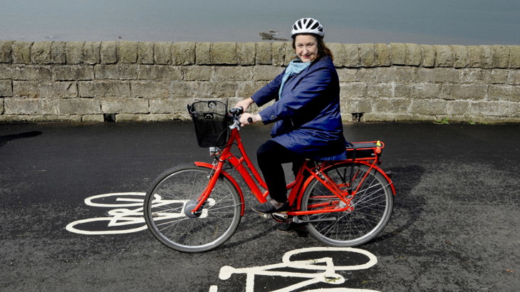 woman on ebike outside on cycle lane
