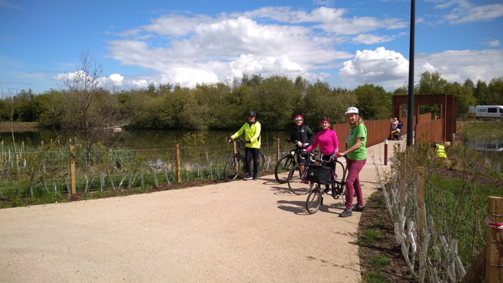 Forth Meadow Community greenway volunteers at National Standard Level 1 cycle training, standing with their bikes on the bridge at Springfield Dam in May 2021