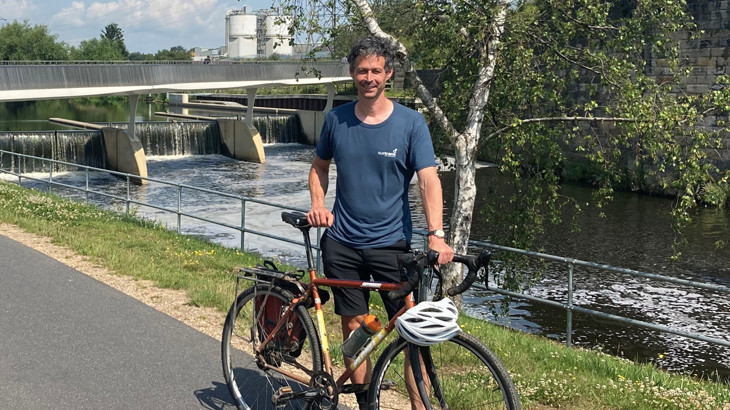 Walk Wheel Cycle Trust Network Development Manager, Mike Babbit, standing with his bicycle on a traffic-free route.
