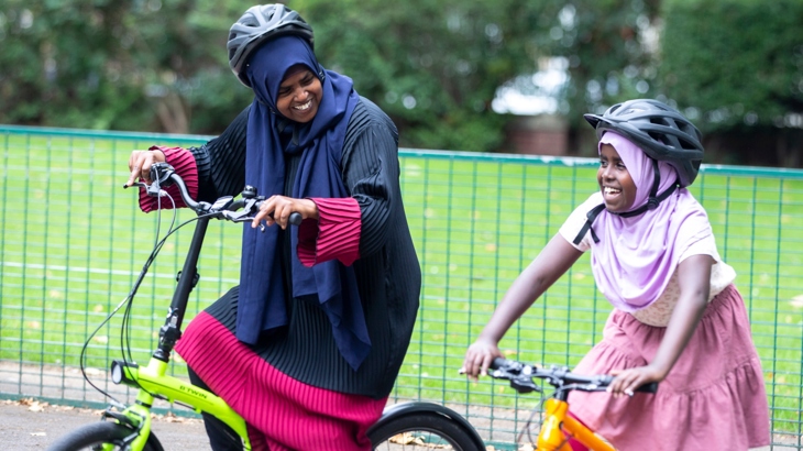 Mother and daughter cycling in Chrisp Street, Tower Hamlets