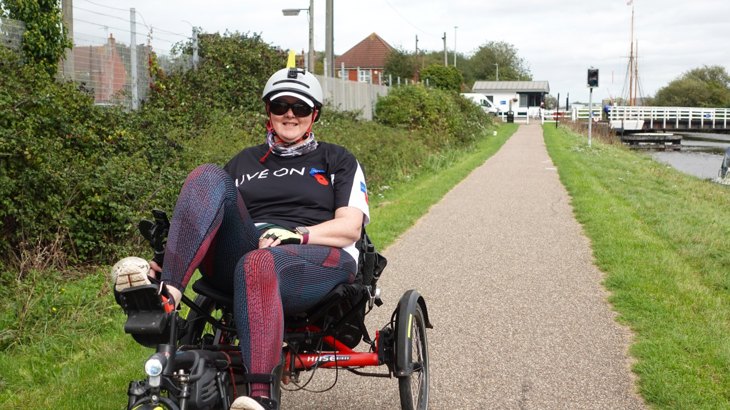 Debbie riding her recumbent trike along the canal near Slimbridge in Gloucestershire