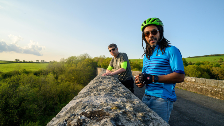 Two men on a traffic-free route atop a viaduct in Dartmoor, Devon.